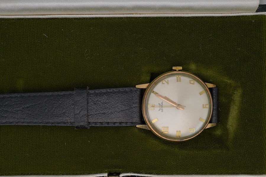 A gentleman's yellow metal Astral manual wind wrist watch, with engraved case back inscription, on a leather strap, with original box and guarantee. Condition - poor to fair